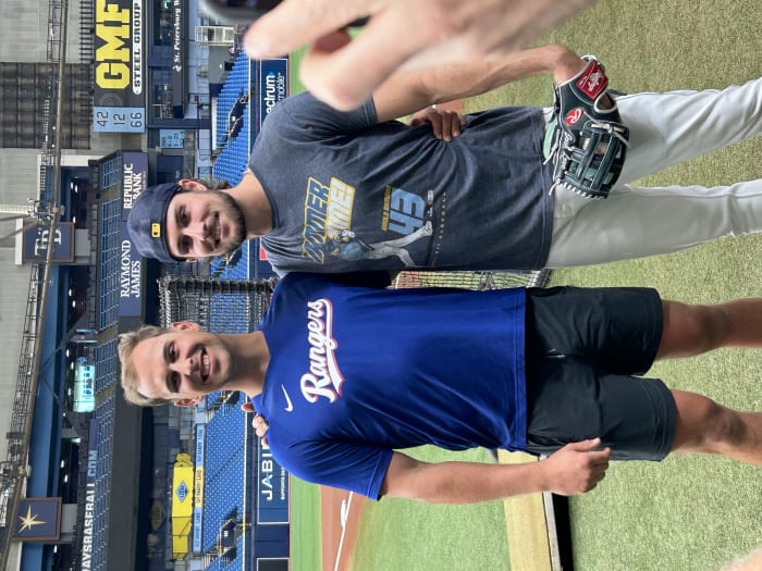 Texas Rangers first baseman Nathaniel Lowe (left) and his younger brother Josh Lower of the Tampa Bay Rays get together before Friday's game. It's the first time they've met at the major-league level. (Photo by Tom Brew)